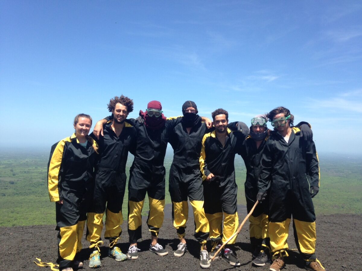 A group of travelers on top of Cerro Negro before going volcano boarding in Nicaragua.