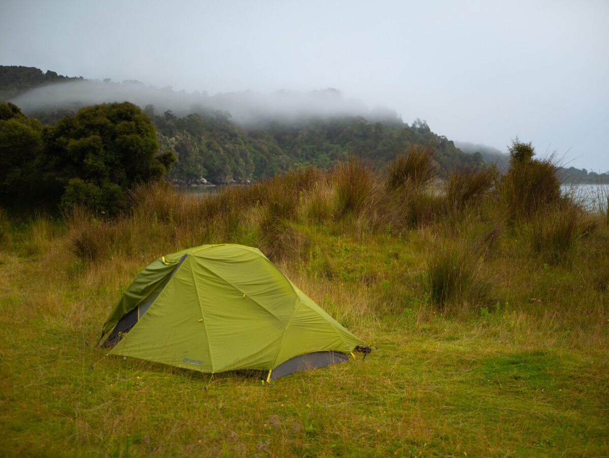 A tent set up at the Maori Beach campsite along the Rakiura Track, on Stewart Island, NZ.