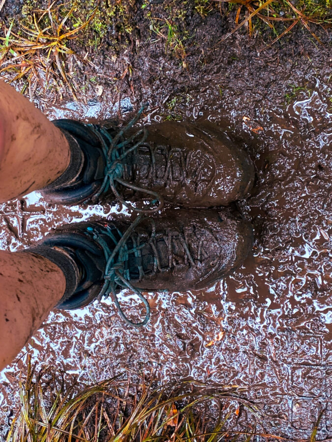 A hiker's muddy boots from the Rakiura Track - Stewart Island, NZ.