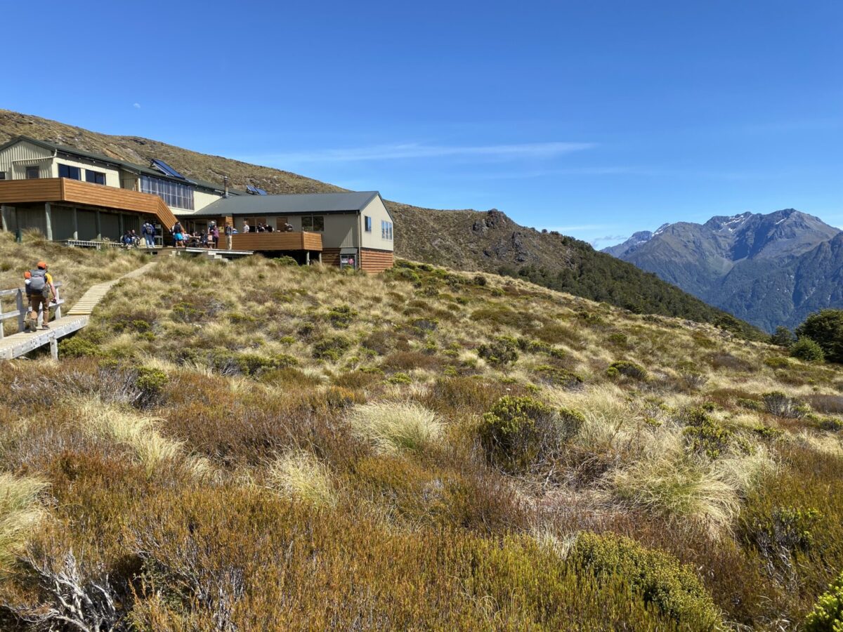 The Kepler Tracks' Luxmore Hut, situated in front of a mountain range in Fiordland National Park.