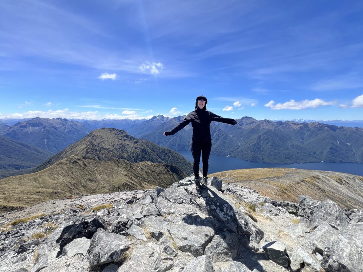 A hiker at the top of Mount Luxmore in New Zealand's Fiordland National Park.