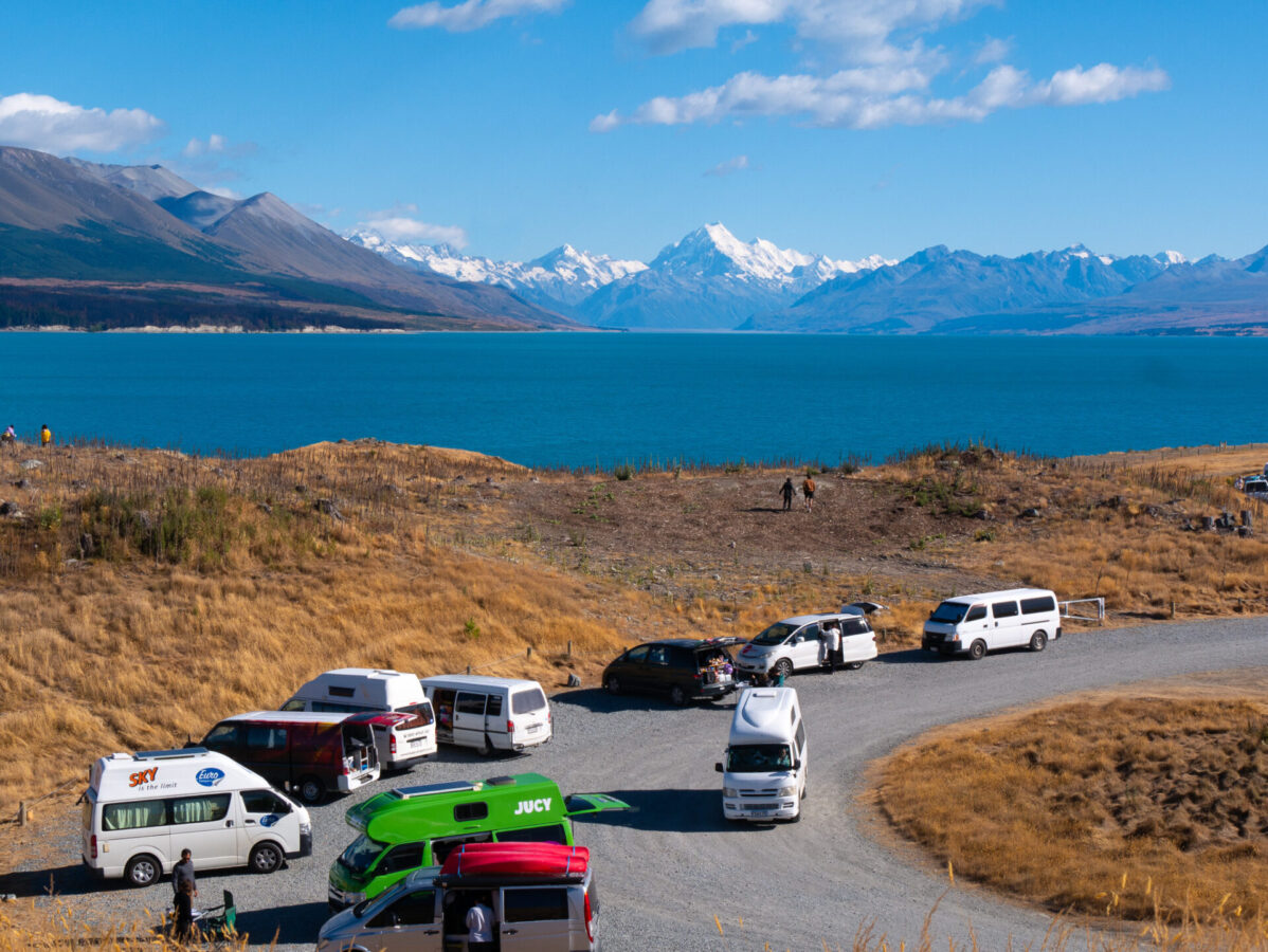 A freedom camping site with many converted campervans near Mount Cook in New Zealand.