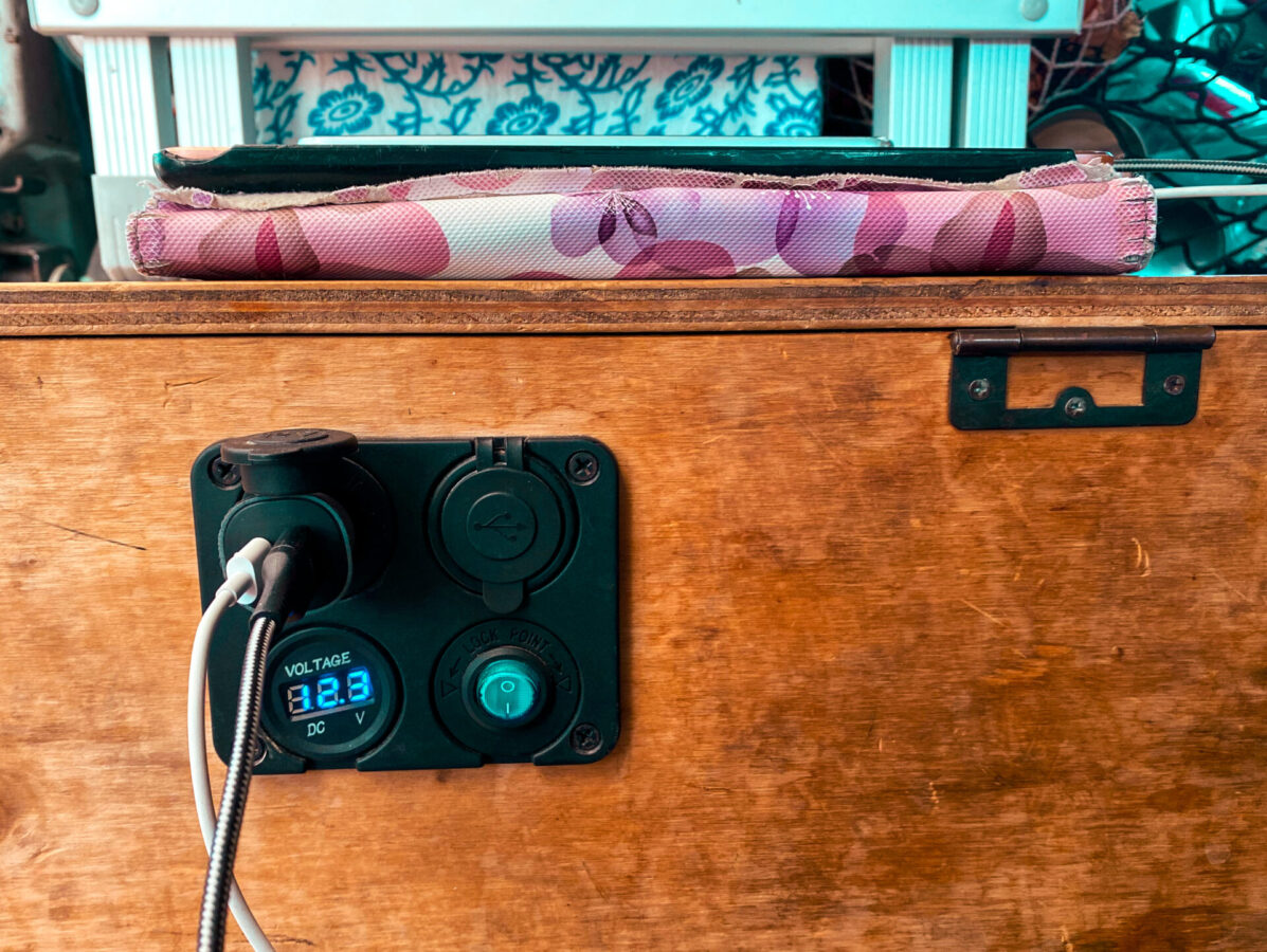 A charging station connected to a second battery in a converted campervan.