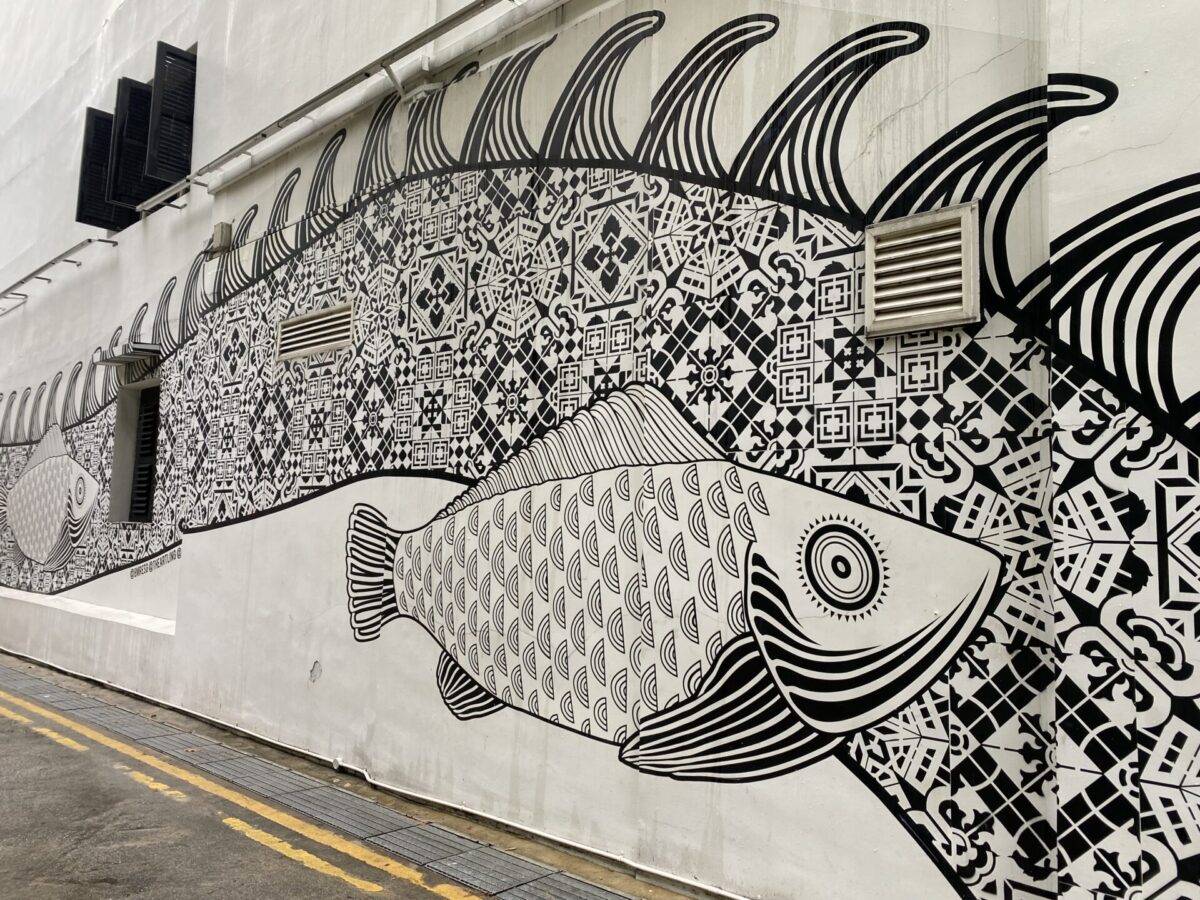 A black and white fish mural on a building in Singapore.