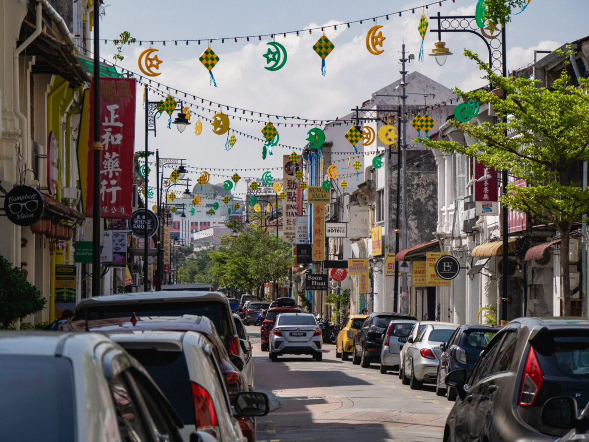 One of George Town, Malaysia's busy streets strewn with lights and symbols of Malaysian culture.