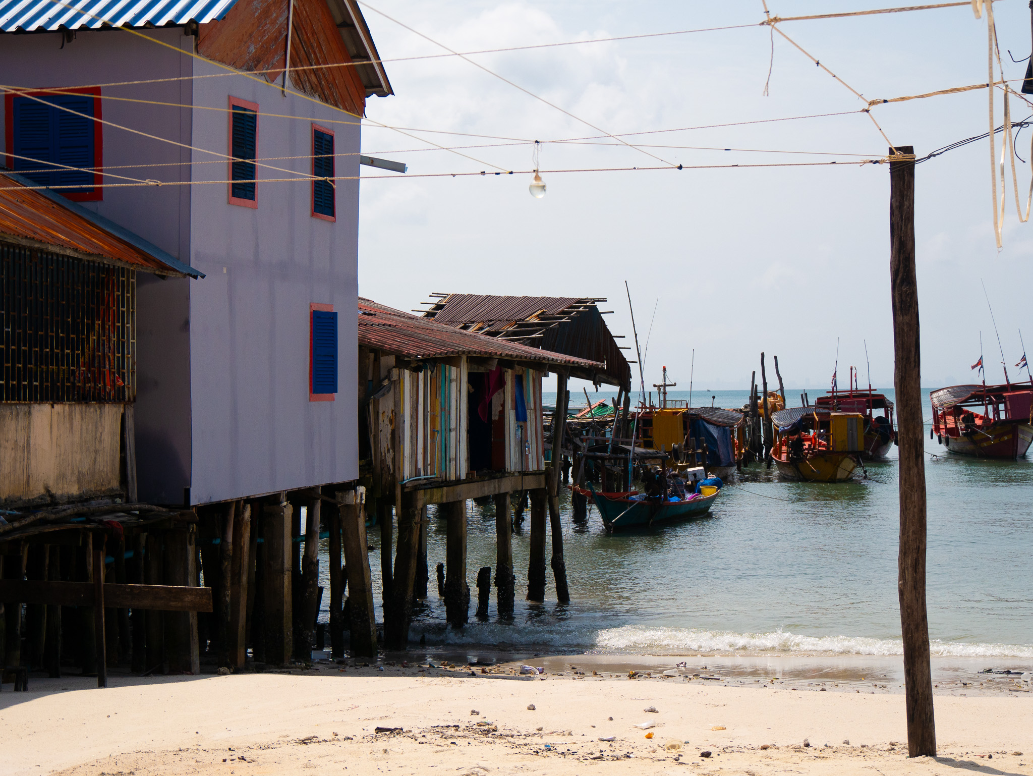 Colorful buildings and boats near the pier on Koh Touch village in Koh Rong, Cambodia.