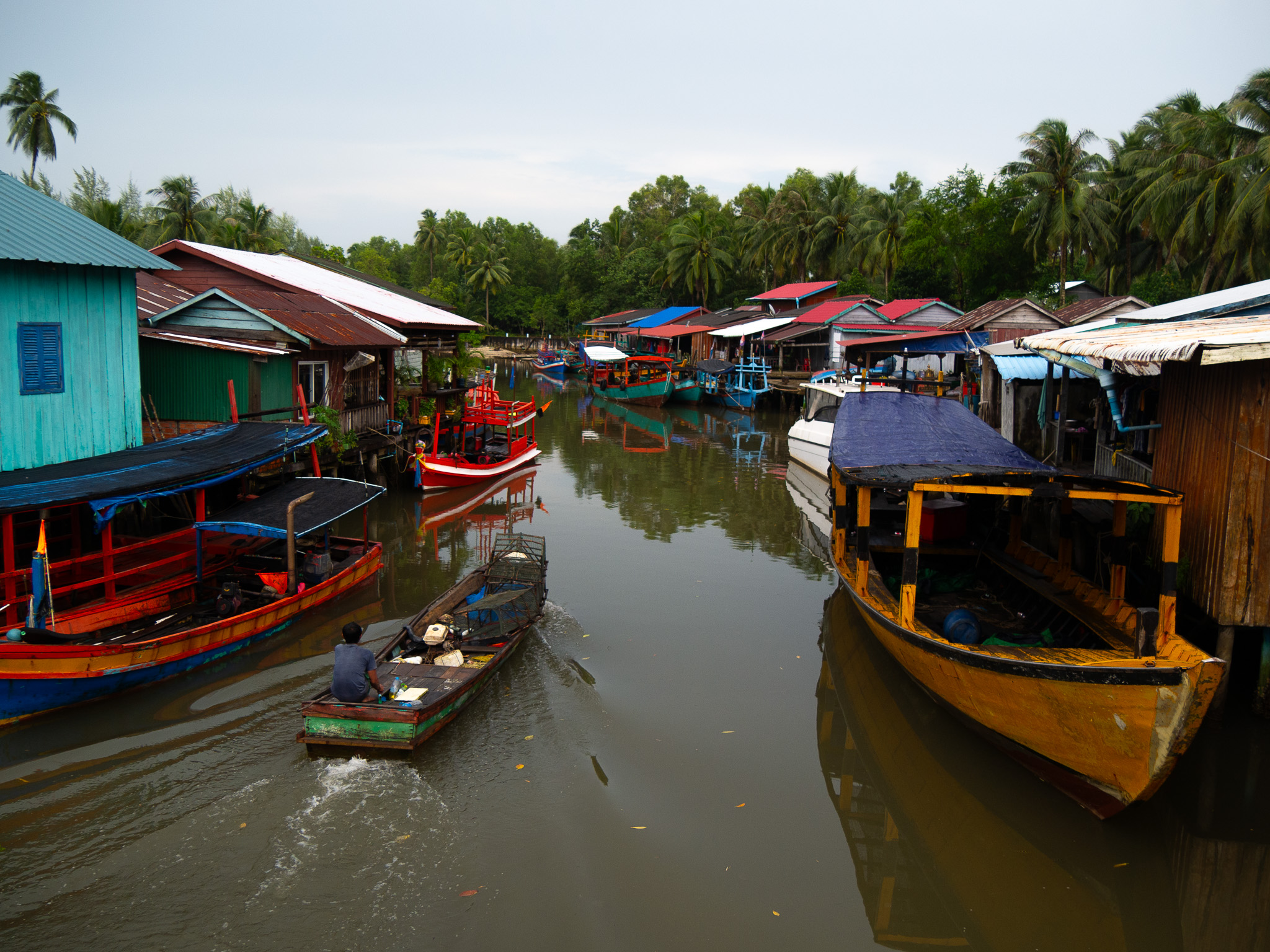 A boat-lined river in Prek Svay fishing village on Koh Rong, Cambodia.