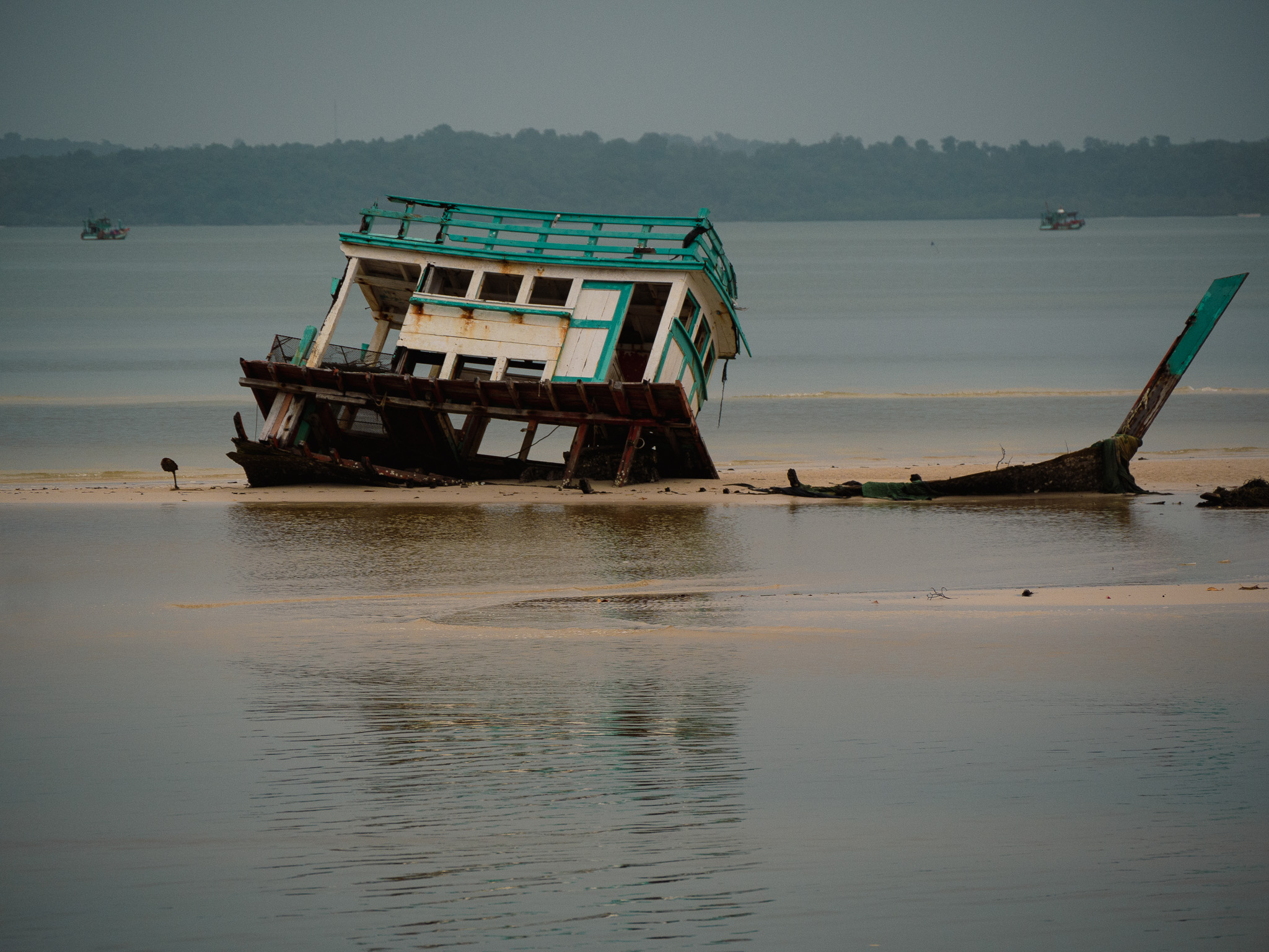 A partially sunken fishing boat in Prek Svay, Koh Rong, Cambodia.