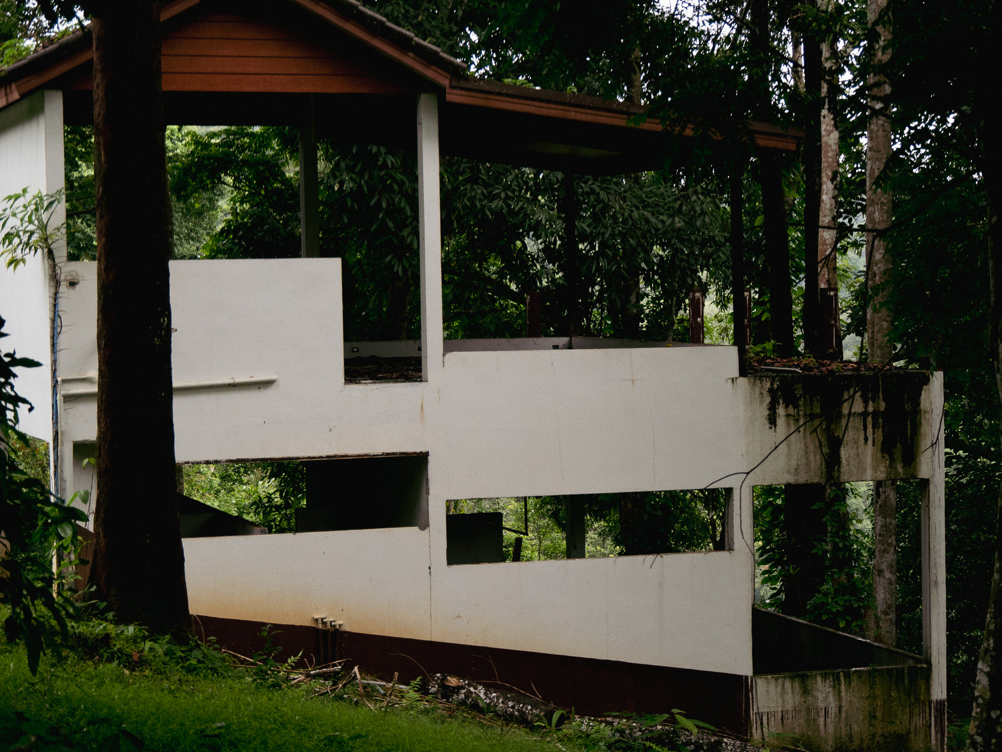 An empty, rundown guesthouse at an abandoned resort on the Bolaven Plateau in southern Laos.