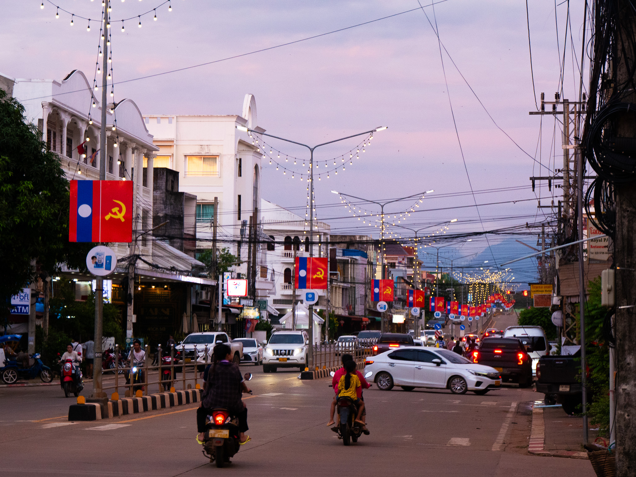 A busy street in downtown Pakse, Laos at sunset.